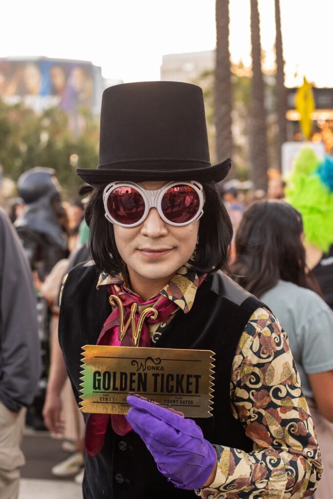 Willy Wonka Cosplayer holding a Golden Wonka Ticket at ComiCon 2023